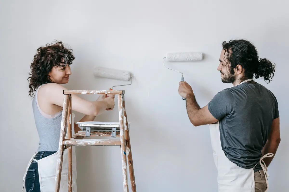 People painting a wall together — painting help in Provo